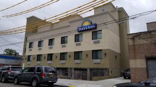 a hotel with a sign on the side of it at Days Inn by Wyndham Brooklyn Marine Park in Brooklyn
