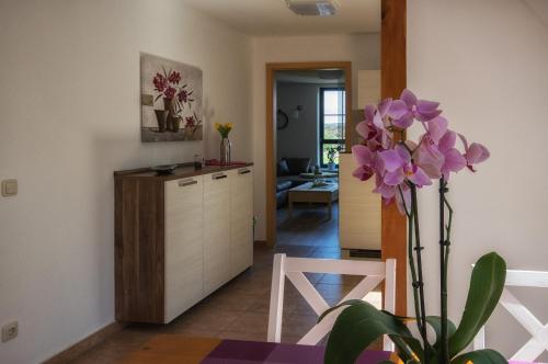a kitchen with a table and a chair and a plant at Gastwirtschaft & Hotel Hallescher Anger in Naumburg