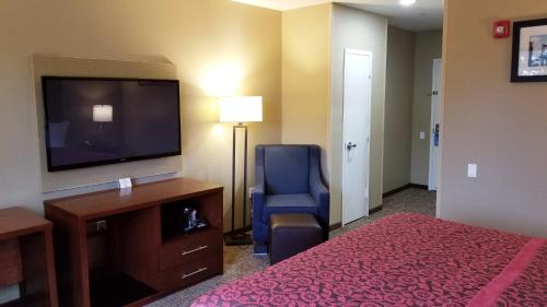 a hotel room with a bed and a flat screen tv at Days Inn by Wyndham Brooklyn Marine Park in Brooklyn