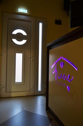 a room with a door with a sign that says true living at Apartment Fine Living 122 in Vršac