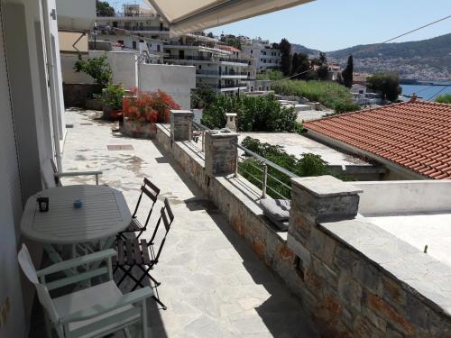 a patio with chairs and a table on a building at Afroessa Studios & Apartments in Samos