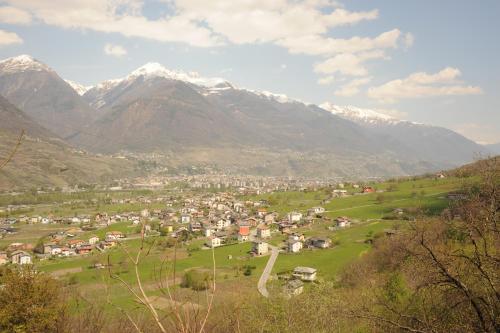 a small town in a valley with snow capped mountains at Agriturismo Stella Orobica in Albosaggia