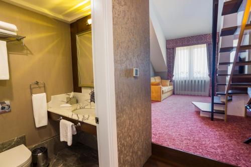 a bathroom with a sink and a ladder in a room at Mell Hotel in Trabzon