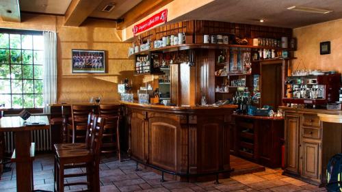 a bar in a restaurant with wooden furniture at Hotel Haus Wagner in Frechen