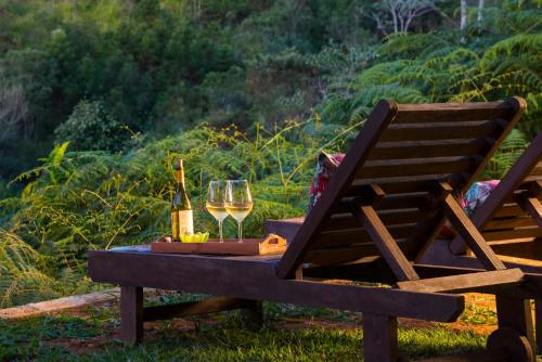 a table with a glass of wine and a bottle at Pousada Terras Altas in Visconde De Maua