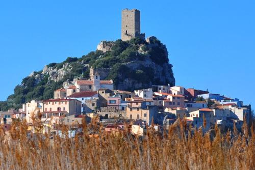 a town on a hill with a castle on top at Agriturismo Orvile in Posada