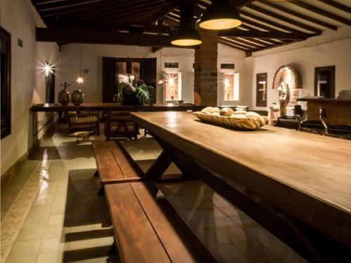 a large room with a large wooden table and chairs at Casa Santamaria Hotel Campestre in Jericó
