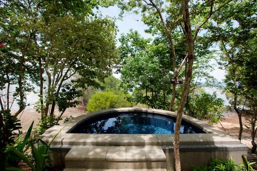 a swimming pool in the middle of a forest at Plataran Menjangan Resort and Spa - CHSE Certified in Banyuwedang