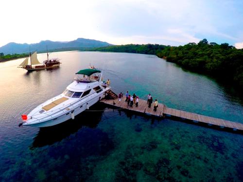 a boat is docked at a dock in the water at Plataran Menjangan Resort and Spa - CHSE Certified in Banyuwedang