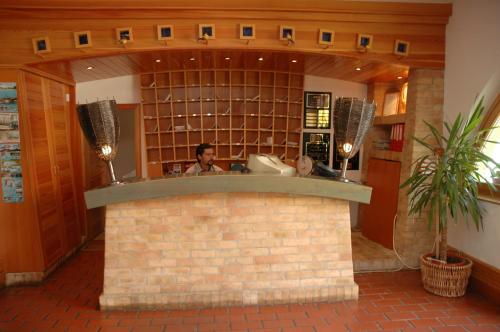 a man sitting at a counter in a kitchen at Abbazia Country Club in Nemesnép