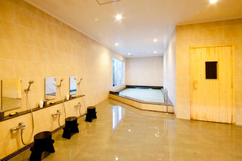 a bathroom with a swimming pool in a room at Sancrest Residence Deltamas in Cikarang