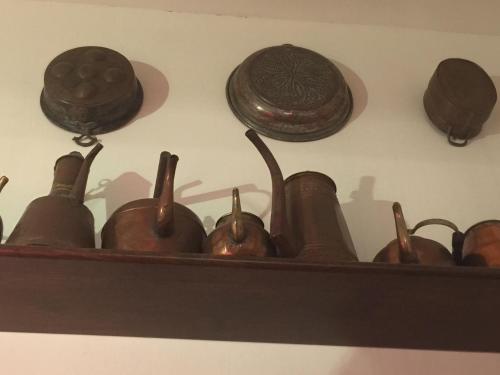 a shelf with a group of pottery on a wall at Lalla's Central Apartment in Tortona