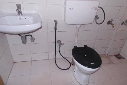 a bathroom with a toilet and a sink at Hotel Span in Kozhikode