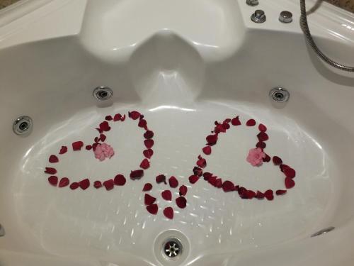 a bath tub with hearts spelled out in a sink at Anatolia cave hotel Pension in Goreme