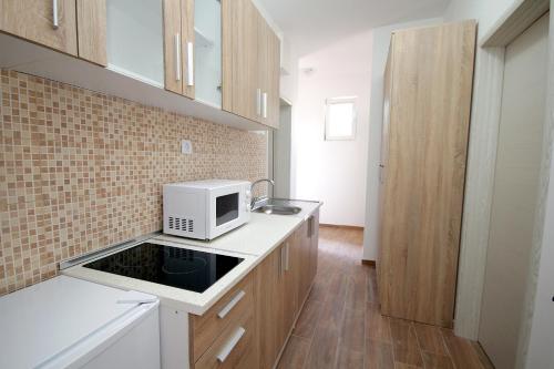a kitchen with a white microwave on a counter at Apartments Centar Sutomore in Sutomore