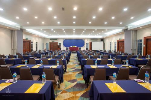 a large banquet hall with blue tables and chairs at Hotel Seri Malaysia Johor Bahru in Johor Bahru
