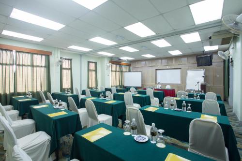 a conference room with blue tables and white chairs at Hotel Seri Malaysia Kuantan in Kuantan