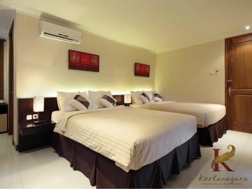 een hotelkamer met 2 bedden in een kamer bij Kertanegara Premium Guest House in Malang