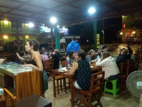 a group of people sitting at tables in a restaurant at RuengsriSiri Guesthouse in Sukhothai