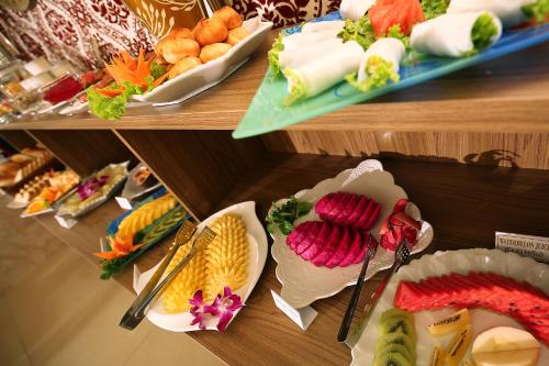 een vitrine met verschillende soorten levensmiddelen op borden bij Aquarius Grand Hotel in Hanoi