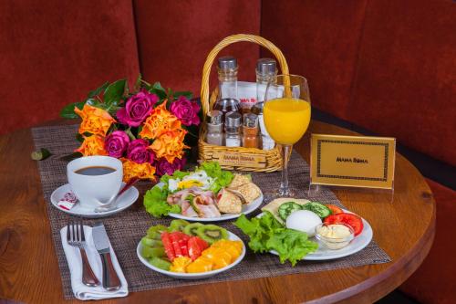 a table topped with plates of food and drinks at Abakan Hotel in Abakan