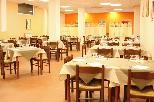 a dining room with tables and chairs with white table cloth at Santuario NS Soviore Cinque Terre in Monterosso al Mare