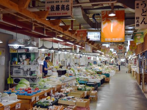 a market with a person standing in the middle of a store at Hotel Pearl City Akita Kanto-Odori in Akita