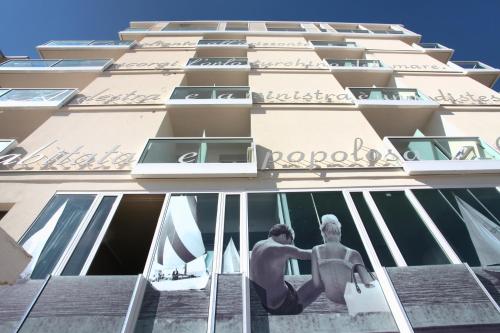 a building with a statue of a man on the window at Residence Terminus in Rimini