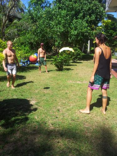 a group of men playing with a ball in the grass at Malika Homestay in Midigama