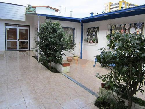 a house with a blue hose attached to a patio at Hostal Andalue Temuco in Temuco