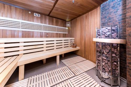 a sauna with a wooden bench and a fire extinguisher at WISH Aqua&SPA Resort in Vishenki