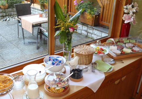a table with a bunch of food on it at Landgasthof Reitsamerhof in Werfen
