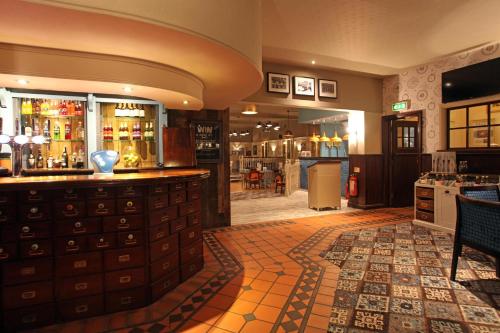 a bar in a restaurant with a counter at Half Moon, Sherborne by Marston's Inns in Sherborne