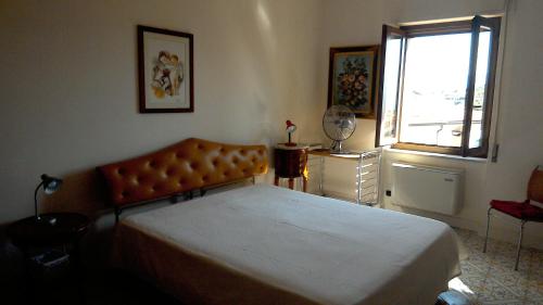 a bedroom with a large bed and a window at Le Stanze di Mamma Pia in Casal Velino