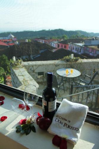 a bottle of wine sitting on a table with a glass at Hotel Boutique La Casona de Don Porfirio in Jonotla