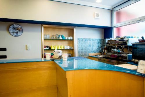 a kitchen with a blue counter in a restaurant at Hotel Ceretto in Busca