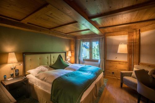 a bedroom with a large bed in a room at Riffelalp Resort 2222m Ski-in & Ski-out in Zermatt