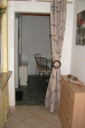 a living room with a table and a curtain at Ferienhaus Annemarie in Senftenberg