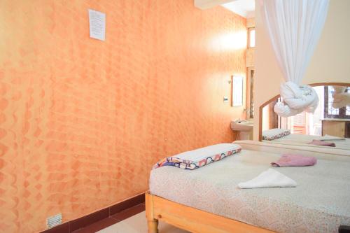 מיטה או מיטות בחדר ב-Lakshmi Heritage Tourist Home