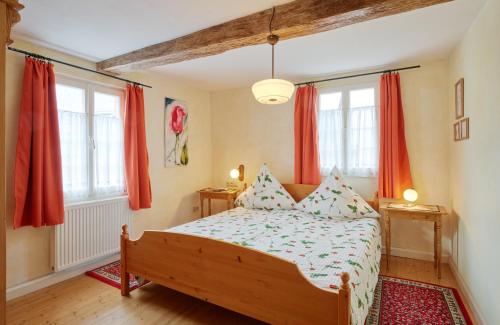 a bedroom with a bed with red curtains at Ferienhaus Wagner in Bernkastel-Kues