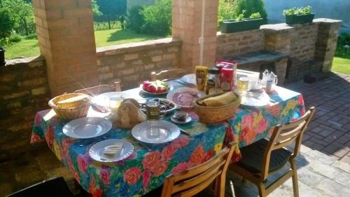a table with plates and bowls of food on it at Bike Stop Duna in Dunaszentmiklós