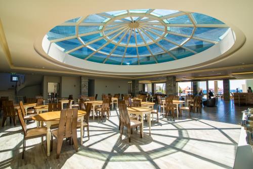 a dining room with a glass ceiling and tables and chairs at The Dome Luxury in Limenaria