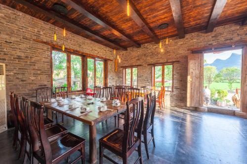 a dining room with a long table and chairs at Rural House in Yangshuo