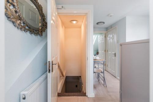 a hallway with a stairway leading into a room at Watford General Suites in Watford