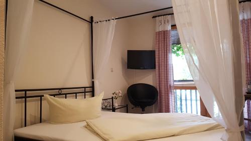 a bedroom with a bed and a tv on a window at Schneiderlein Hotel in Limbach-Oberfrohna