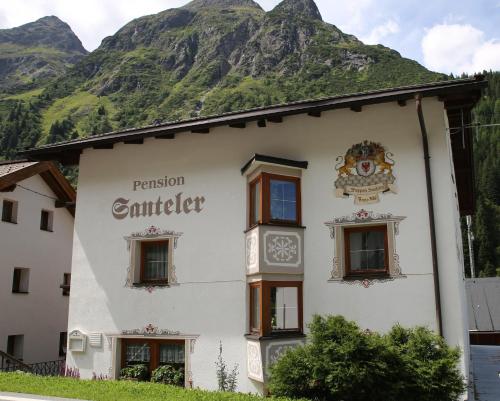 a building in front of a mountain at Gasthof Pension Santeler in Sankt Leonhard im Pitztal