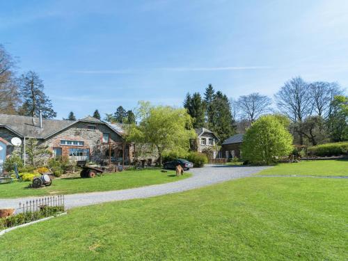 a driveway leading to a yard with houses at Bièvre Forest-Edge Retreat in Bellefontaine