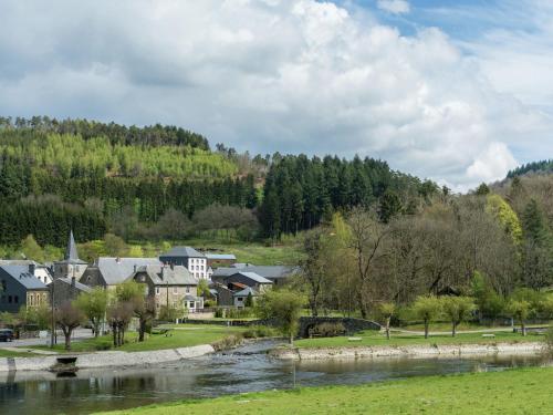 a town next to a river and a mountain at Bièvre Forest-Edge Retreat in Bellefontaine