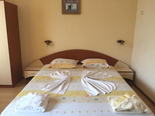 a bed in a bedroom with two pillows on it at Guest House Hetodon in Sozopol