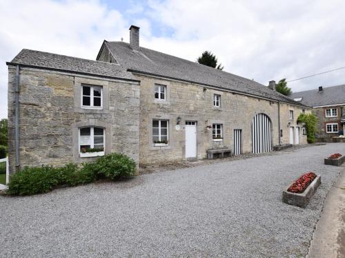 an old stone house with a driveway at Authentic Cottage in Weris with Private Garden in Weris